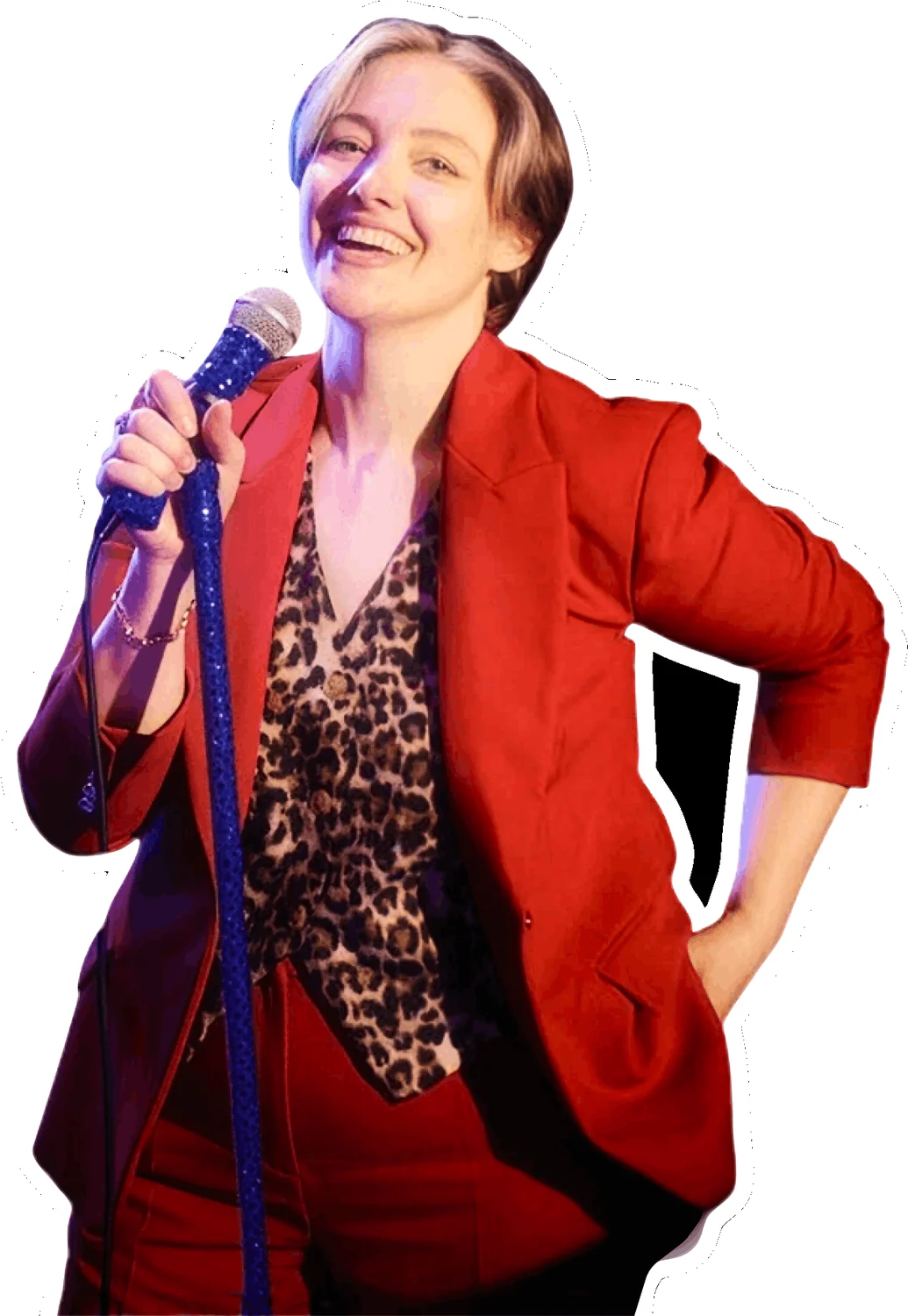 Katie Martell laughing at the mic in a red suit