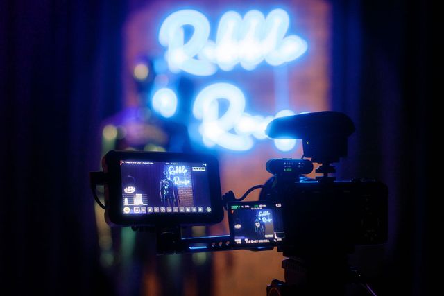 A camera framing the neon sign